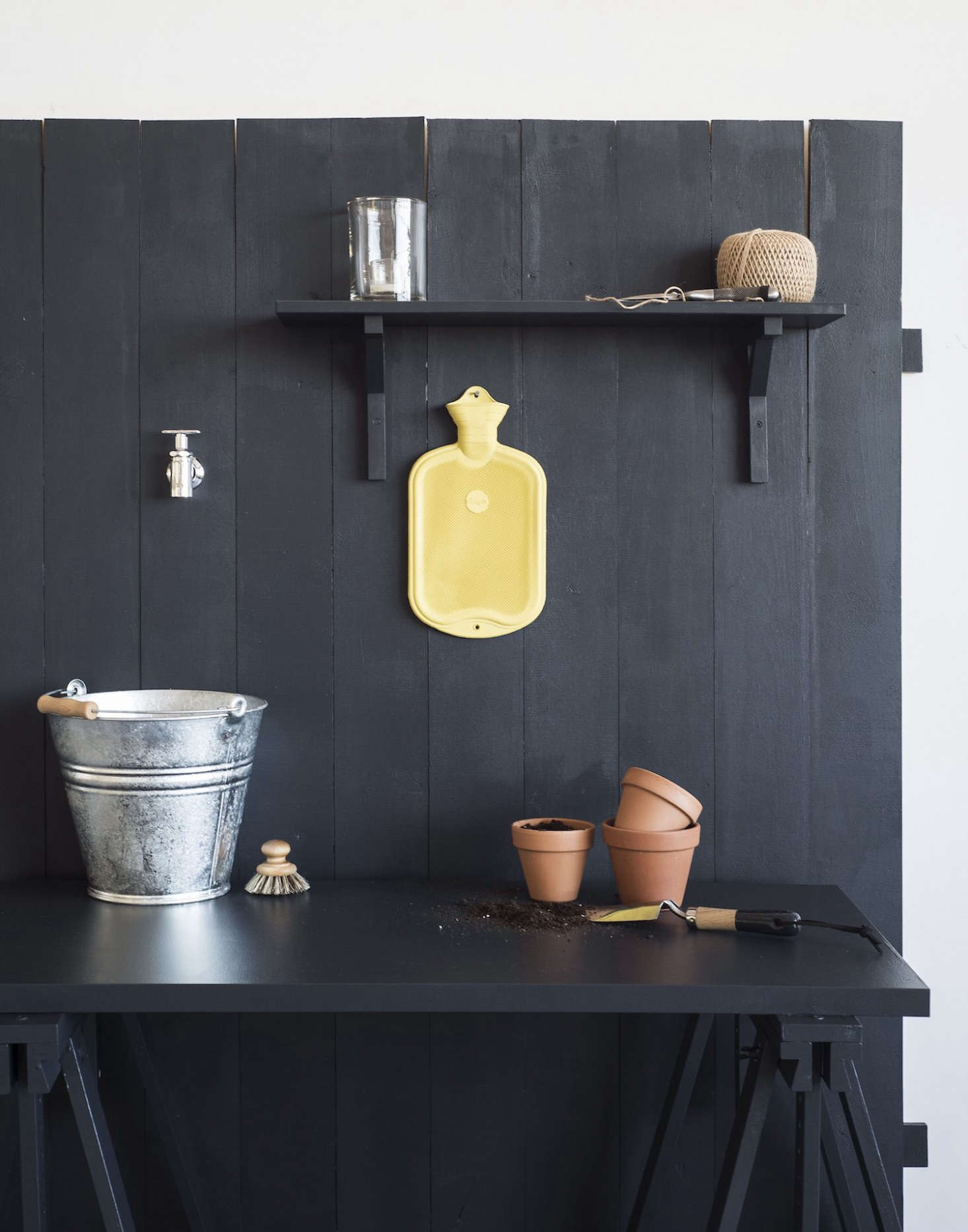 For a simple outdoor sink, all you need is a water tap, a tabletop or shelf, and a pail or pot to catch water.