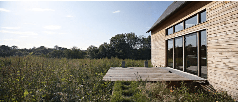 A simple wooden deck floats in a meadow. For more of this project, see Architect Visit: Lode Architecture in Normandy.