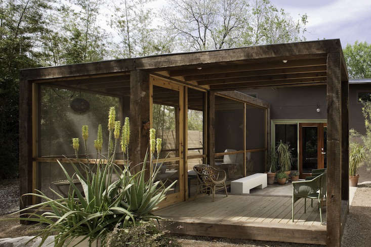 A breeze-capturing screened pavilion from San Antonio, Texas-based Poteet Architects has a rough-hewn timber frame and a covered entry platform for shade and rain protection. Photograph by Chris Cooper, from Architect Visit: Screened Porch by Poteet Architects in San Antonio, Texas.