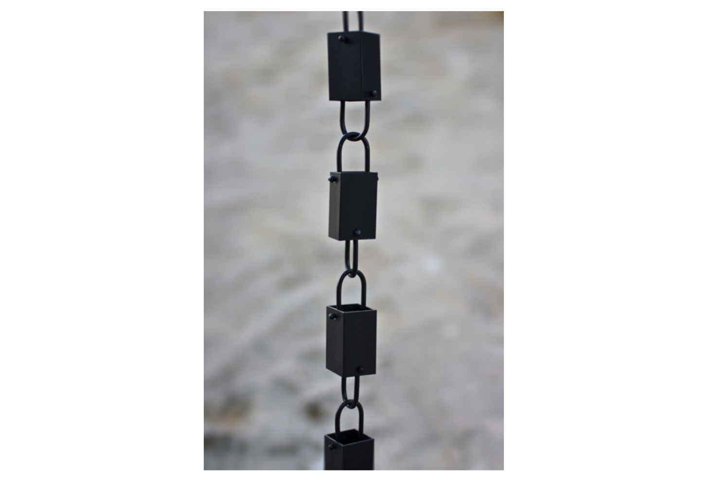 A Square Link Black Rain Chain is made of high quality aluminum finished in a flat black powder coating. It is $49.95 for an 8.5-foot length at Rain Chains Direct.