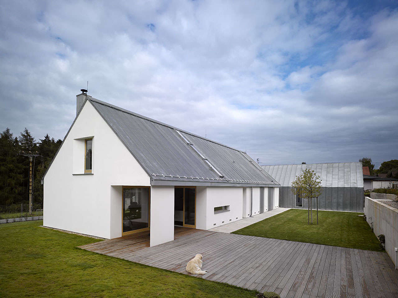 Prague-based Studio Pha designed two barn-like structures for a family compound, connected by grade-level decking. Photograph by Filip Slapal, from Architect Visit: Barn-Like Living, Only Better.