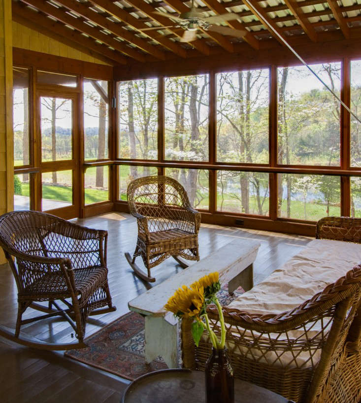 This screened porch is one of four porches in this home. “It is a bit unusual to build so many porches on a new residence as budget constraints and modern air conditioning usually rule out all but the most modest examples,” says the architect. “However, the desire to live indoors/outdoors made them essential.” Photography by Ruth and Marcus Di Pietro, from The Architect Is In: Romancing the Country in Nashville, Music and Porches Included.