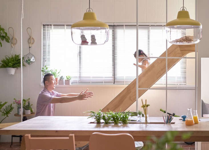 Visible play equipment, including a slide, is part of the design.