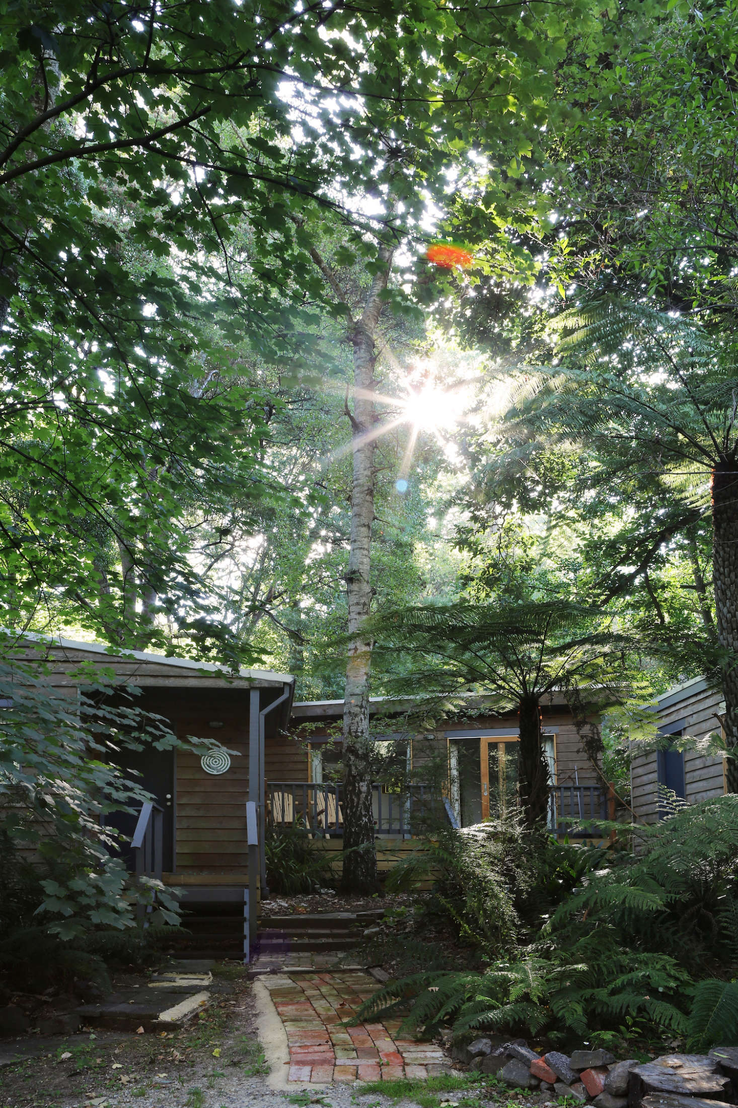 Owner Jeremy Wortsman says the verdant gardens and surrounding landscape are what drew him to the site in the first place. Filled with native greenery and bordered by a winding creek, the retreat is located in Belgrave, Australia, just 45 minutes outside of Melbourne.