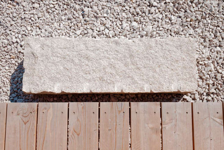 The stoop is a single stone slab set in gravel.