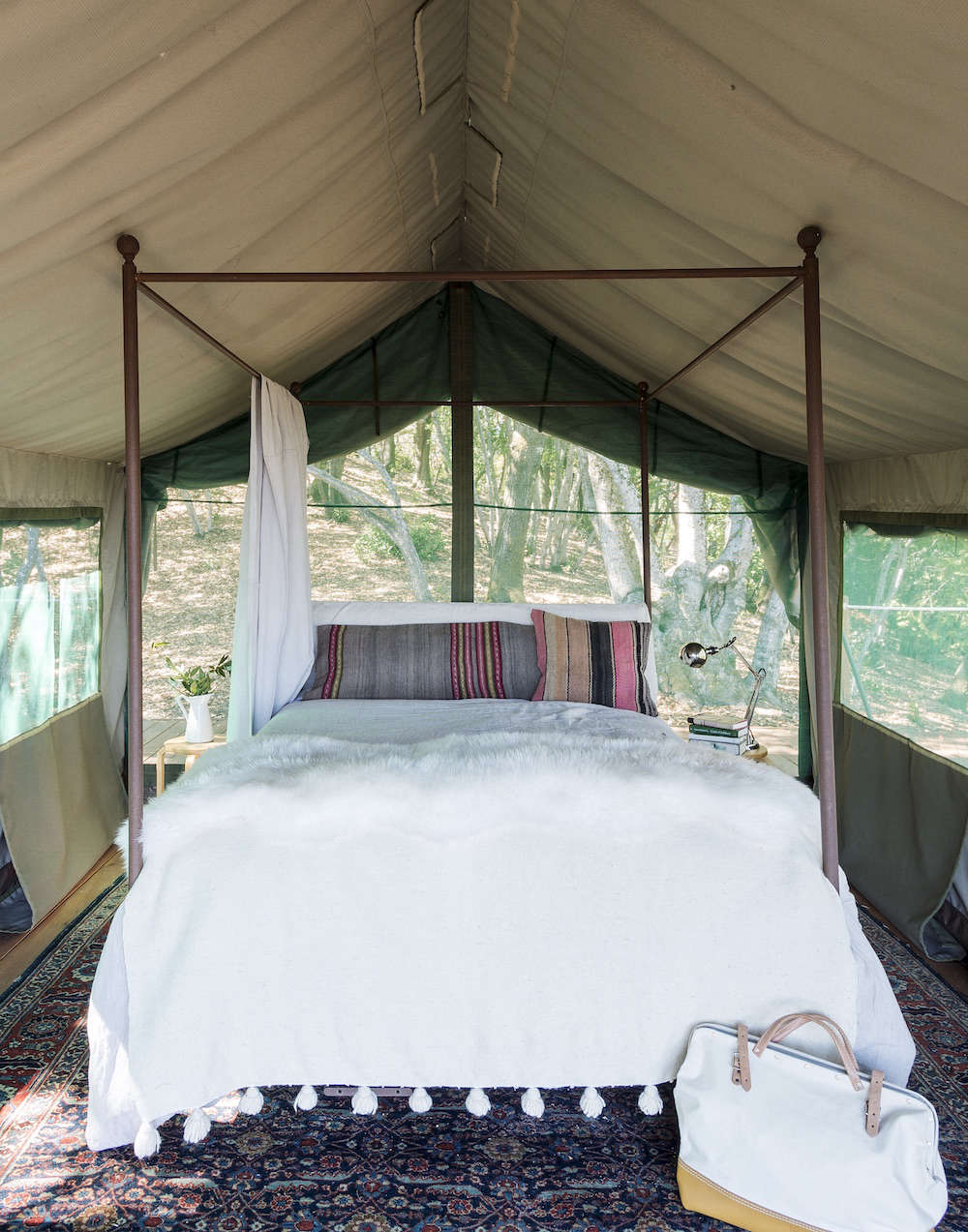 White and Wood Outdoor Glamping Bed in Tent