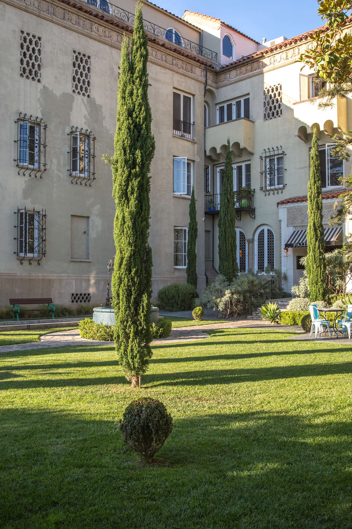 Mediterranean look hotel in Santa Monica with tall cypress trees