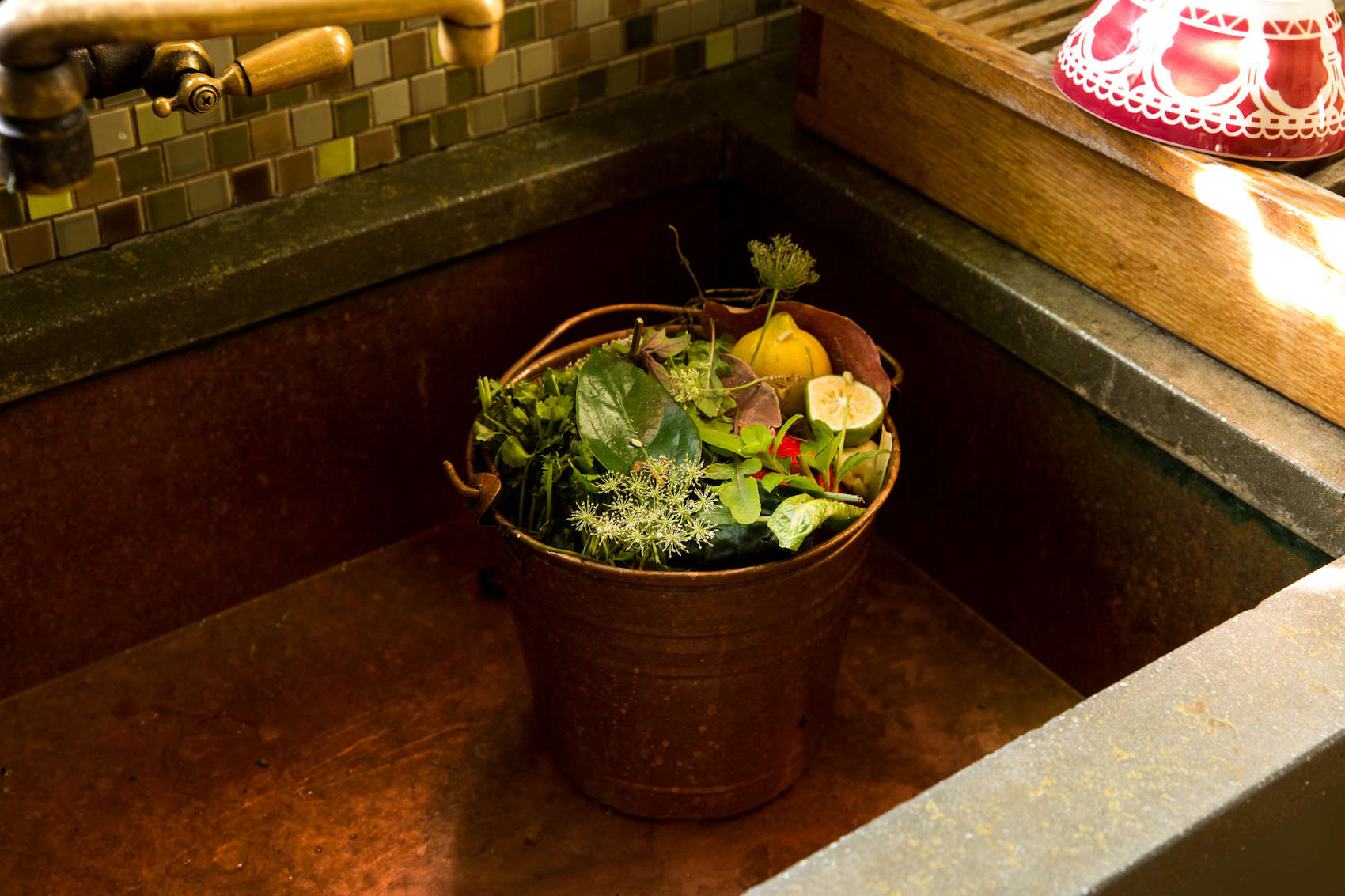 In her Berkeley, California kitchen, chef Alice Waters tosses scraps in a copper pail and empties the contents as soon as it’s full. Photograph by Daniel Dent.