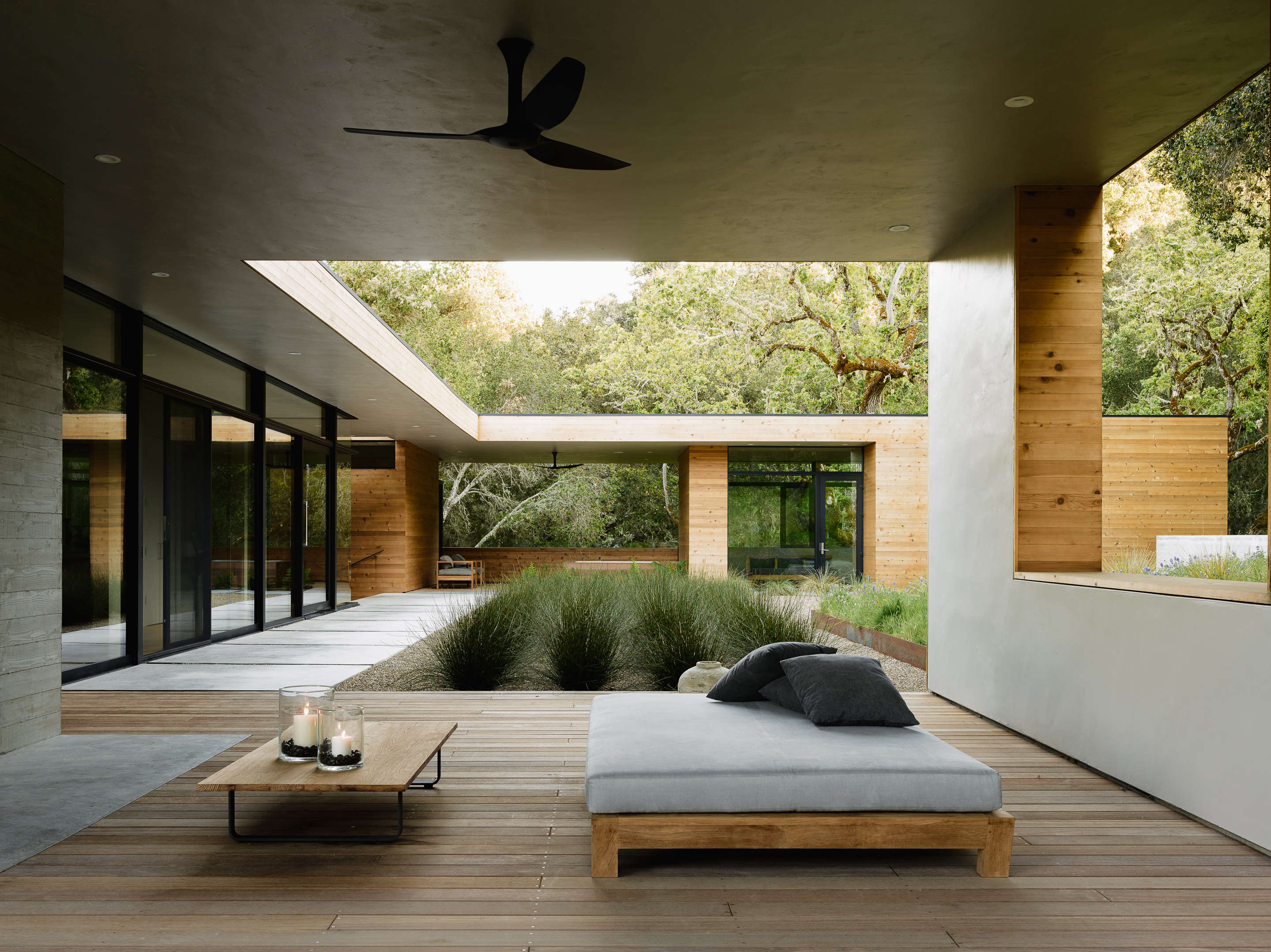 In Carmel Valley, California architects Sagan Piechota, and contractors Stocker Allaire designed an outdoor living room with plaster walls and a batu wood deck, jutting off the main, indoor living room. Photograph by Joe Fletcher courtesy of Sagan Piechota Architecture, from The California Life, Outdoor Living Room Included.