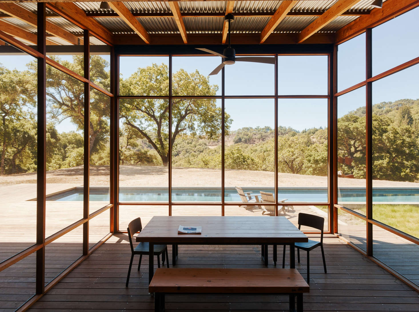 A screened dining porch by architect Malcolm Davis overlooks the pool. Both the decking and screen frame are made of rot-resistant ipe wood, while the building’s framing lumber is Douglas fir. Photograph courtesy of Malcolm Davis, from Swimming Pool of the Week: A Rustic Family Campground—with a Lap Pool.