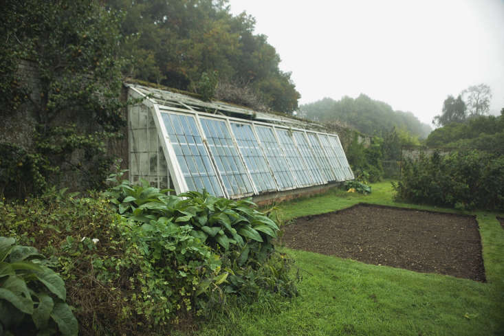 A too-big greenhouse in an English walled garden.