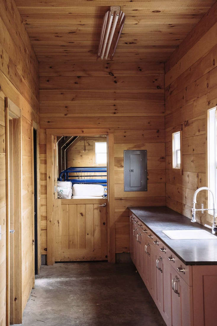 A mudroom with bathroom, laundry, and storage links the two wings of the barn. The wash-up cabinet has a soapstone countertop and is painted in Farrow & Ball&#8\2\17;s Cinder Rose—&#8\2\2\1;an appealingly slightly muddy pink, which in the light of the barn looks like it could have been from the \1940s,&#8\2\2\1; said Berman.