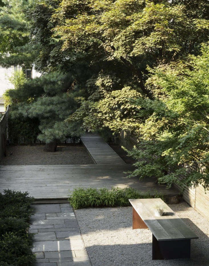 The neighbors&#8\2\17; Japanese maple trees (at right) create a bower and privacy barrier.