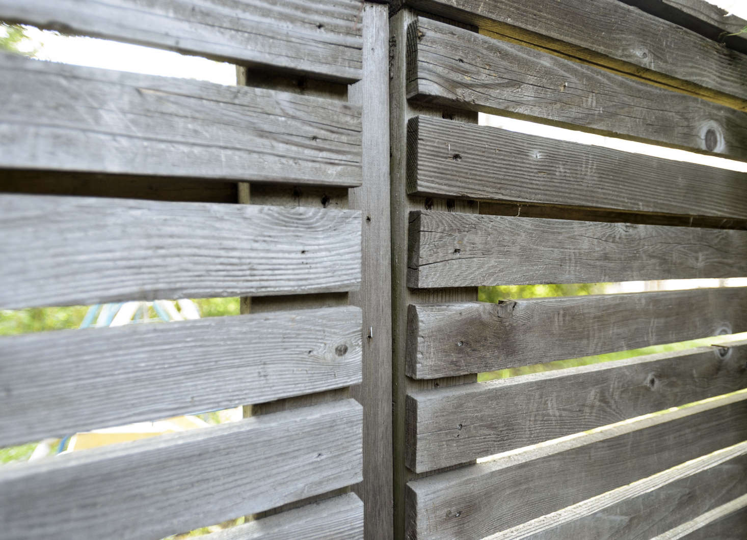 Open spaces between fence slats allow light to enter a garden, making a Brooklyn backyard feel airier.