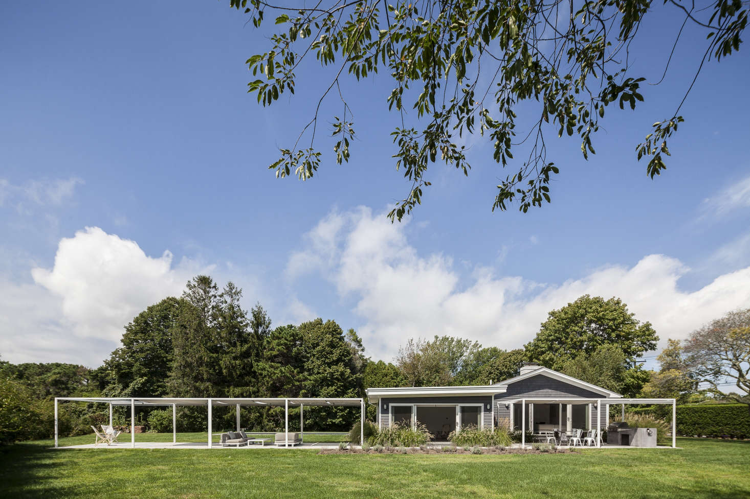 The clean lines of two covered verandas are extensions of the ranch house.
