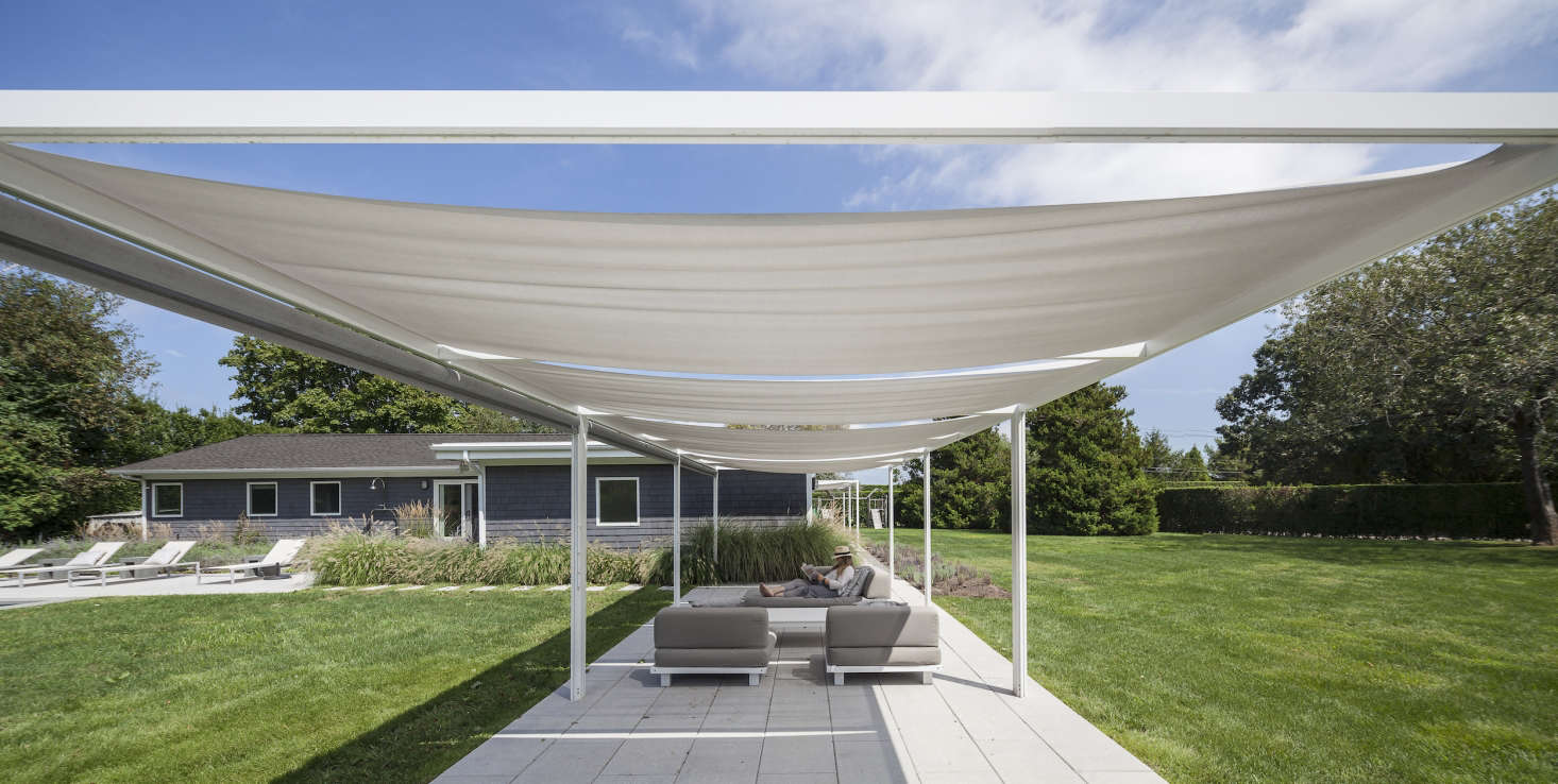 Under the shade sail.