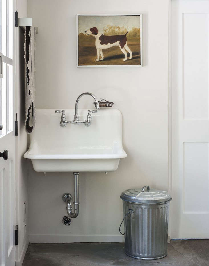 An old-fashioned galvanized trash can holds dog food.