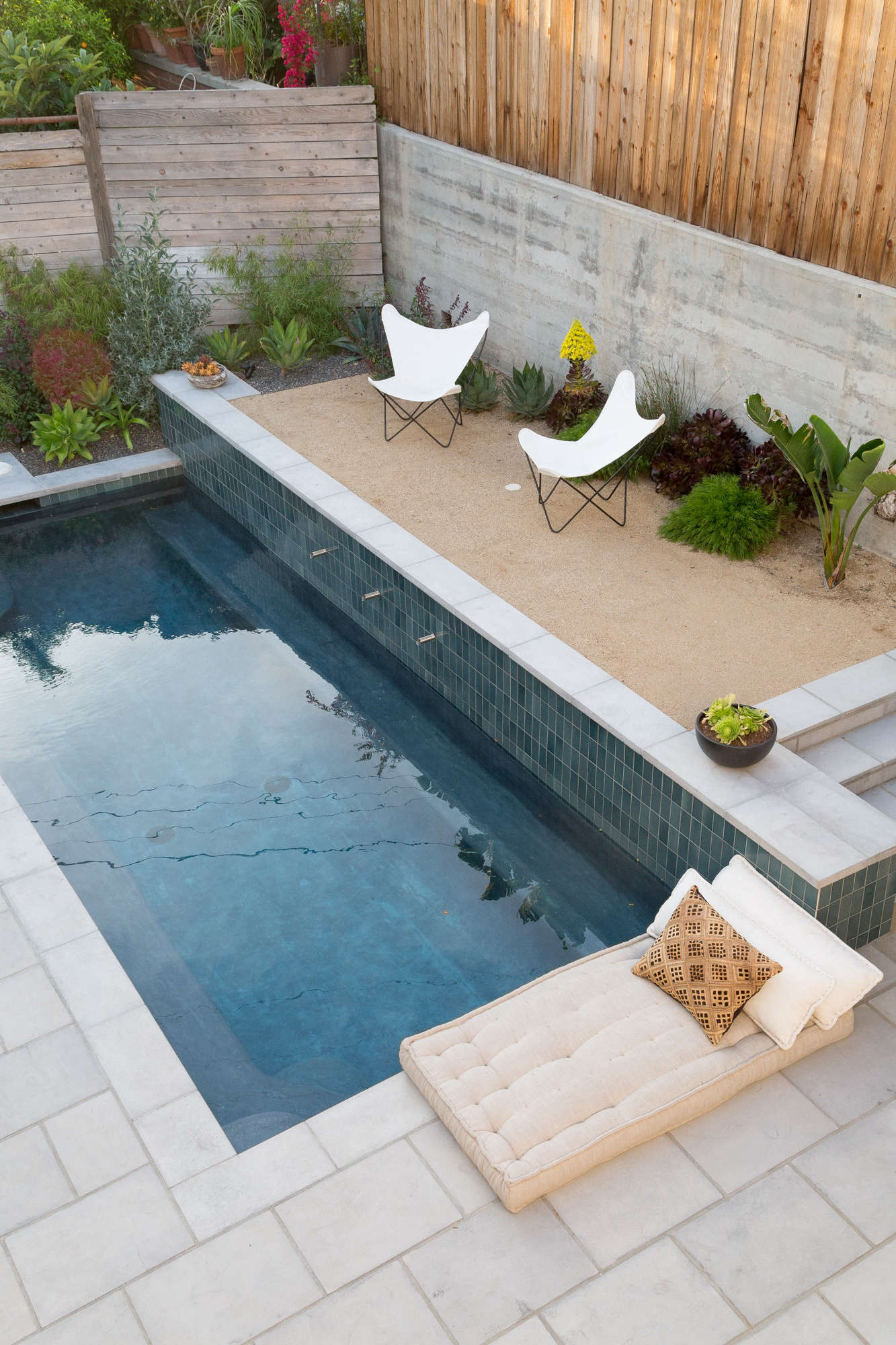 Next to the pool, a gravel courtyard is like a luxe mini beach. (See The New Gravel Backyard: Inspiring Landscape Designs for more ideas.) Underwater are built-in ledges for sitting (and sipping on a drink).
