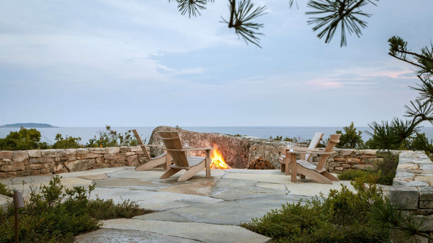 The angled boulder in front of the fire pit is the single largest rock placed on the site. The Adirondack chairs are from Crate & Barrel (though they
