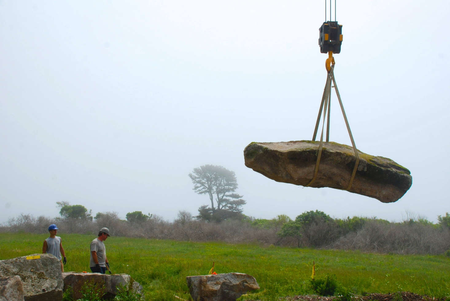 A boulder being laid on the site via crane. Photograph by Todd Richardson.