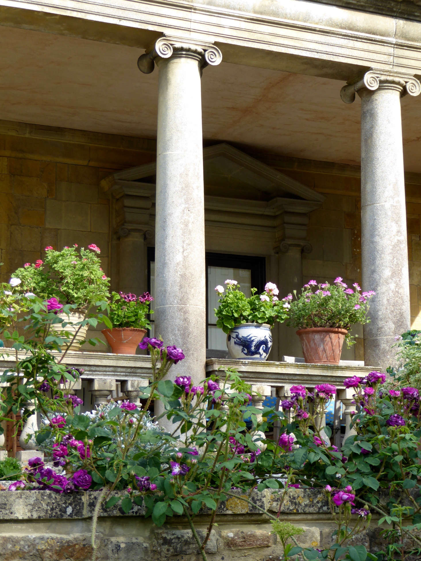 Mismatched pots adds charm. For more of this garden, see Ideas to Steal from the Romantic Gardens at Kiftsgate Court. Photograph by Clare Coulson.