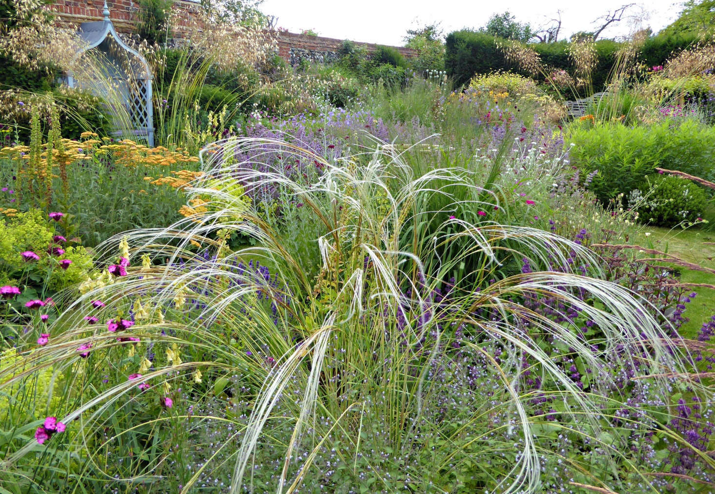 The formal garden is split into four roughly symmetrical beds and is very much influenced by the new perennial movement, as well as by Beth Chatto (whose nearby nursery at Elmstead has provided lots of plant inspiration).