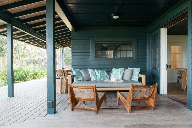 A low wooden deck wraps around a beach cottage to connect it to  the surrounding landscape. Photograph by Kate Holstein, from Vacation Rental: Maui Beach Cottage with a Tropical Garden.