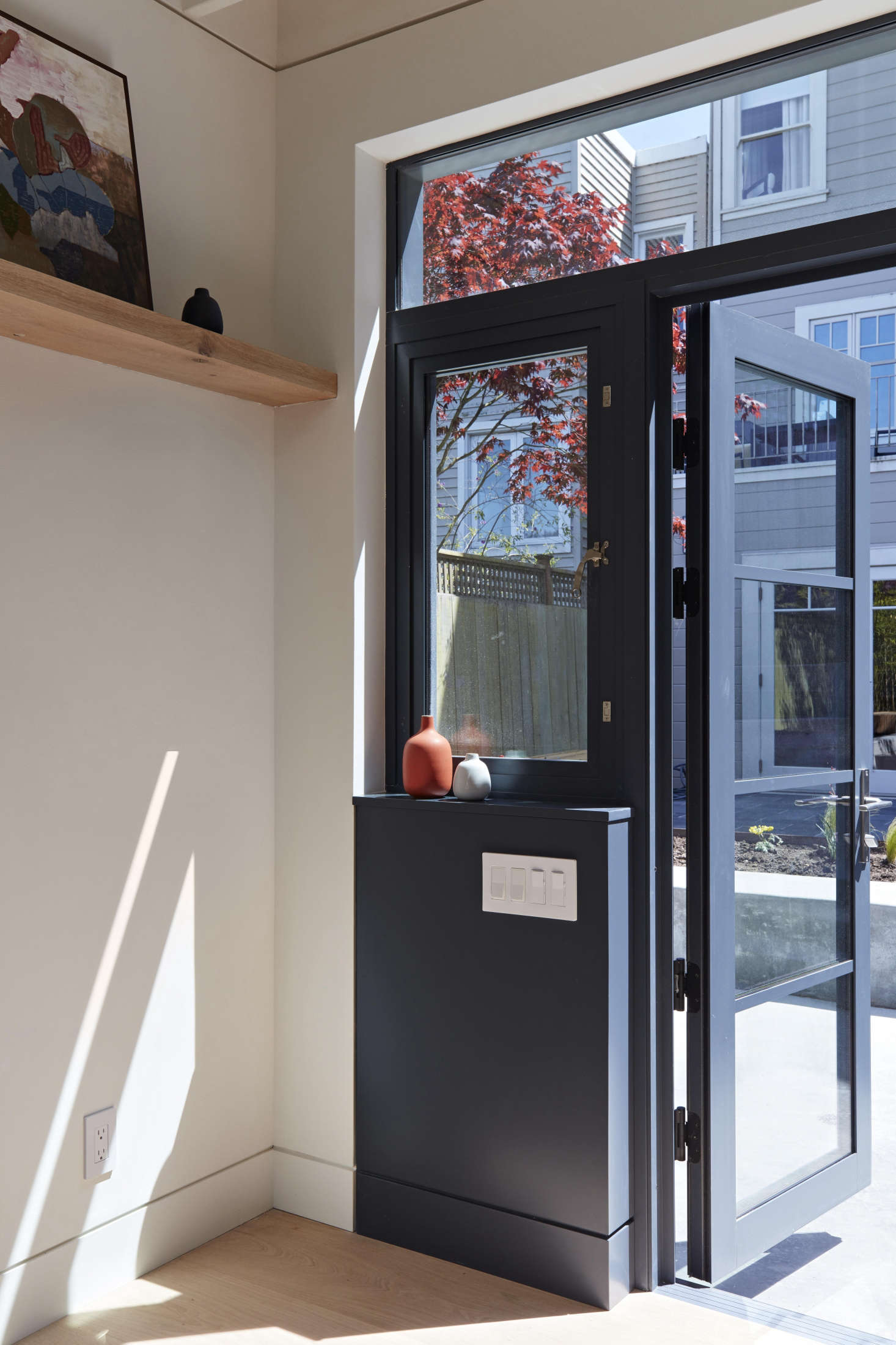Stepping inside the studio. A newly installed wall of painted aluminum windows and doors connects the studio to the lower patio. (For a similar look in steel, see Hardscaping data-src=