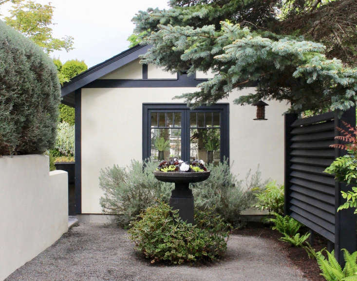  An underplanting of Persicaria &#8\2\16;Purple Fantasy&#8\2\17; softens a planter in the reclaimed driveway. Gergel restored the old garage and now uses it as a studio.