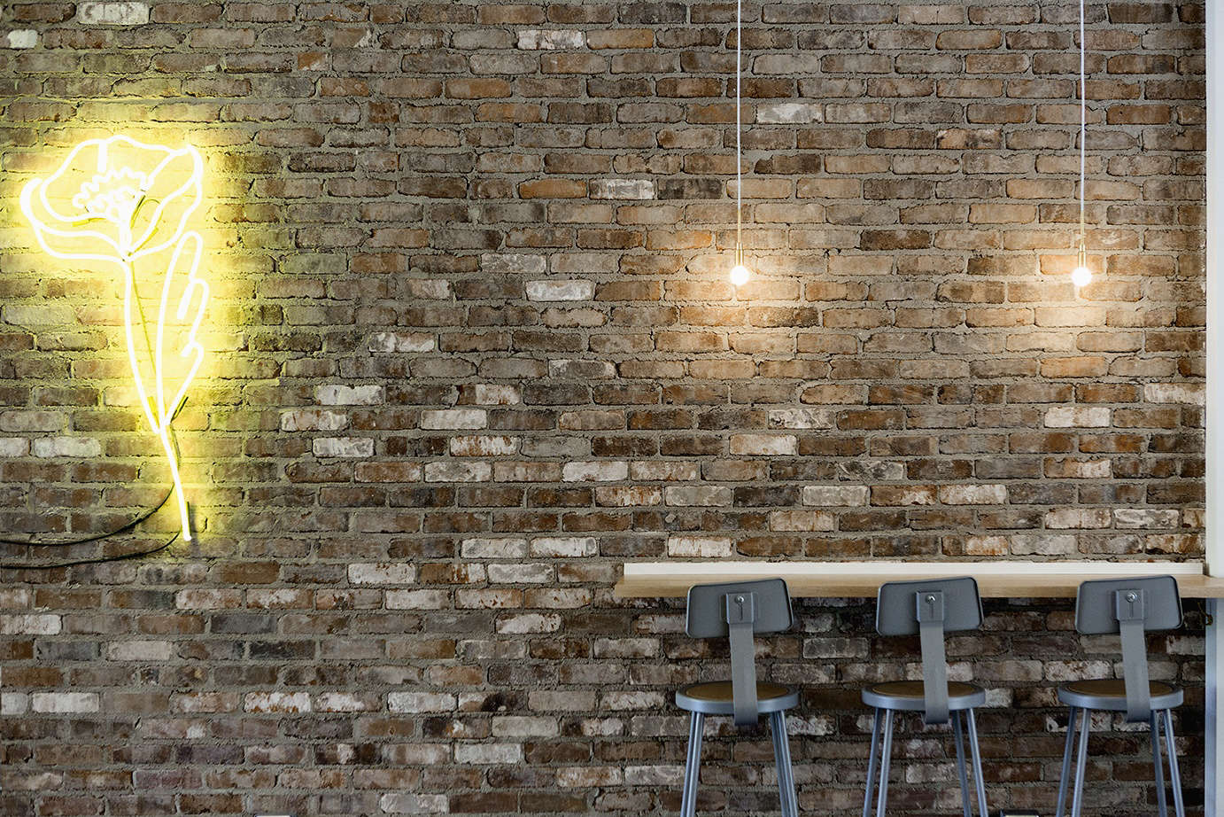 A signature neon bloom adorns a restored wall at Le Butterblume. Photograph by Marie-Reine Mattera.