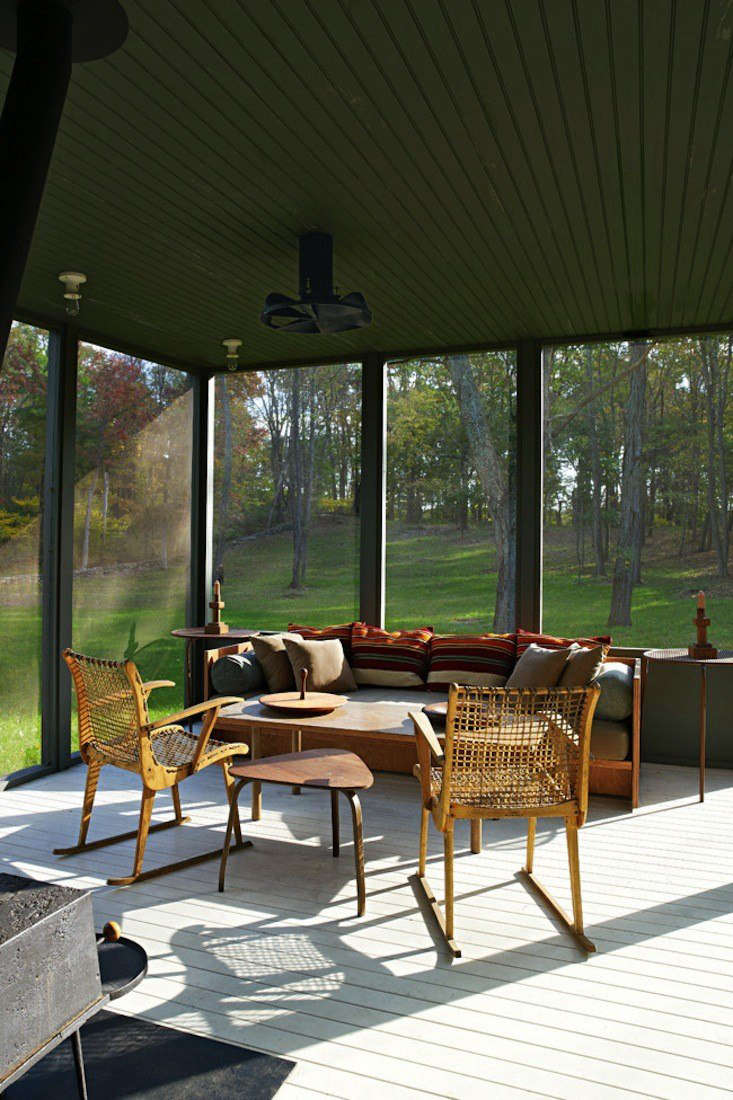 Architects Calvin Tsao and Zack McKown’s screened porch at their weekend place in Rhinebeck, New York has pleasing blend of green walls (so dark they border on Gothic) and midcentury Danish antiques. Photograph by Richard Powers for Tsao & McKown Architects, from Steal This Look: The Perfect Screened Porch.