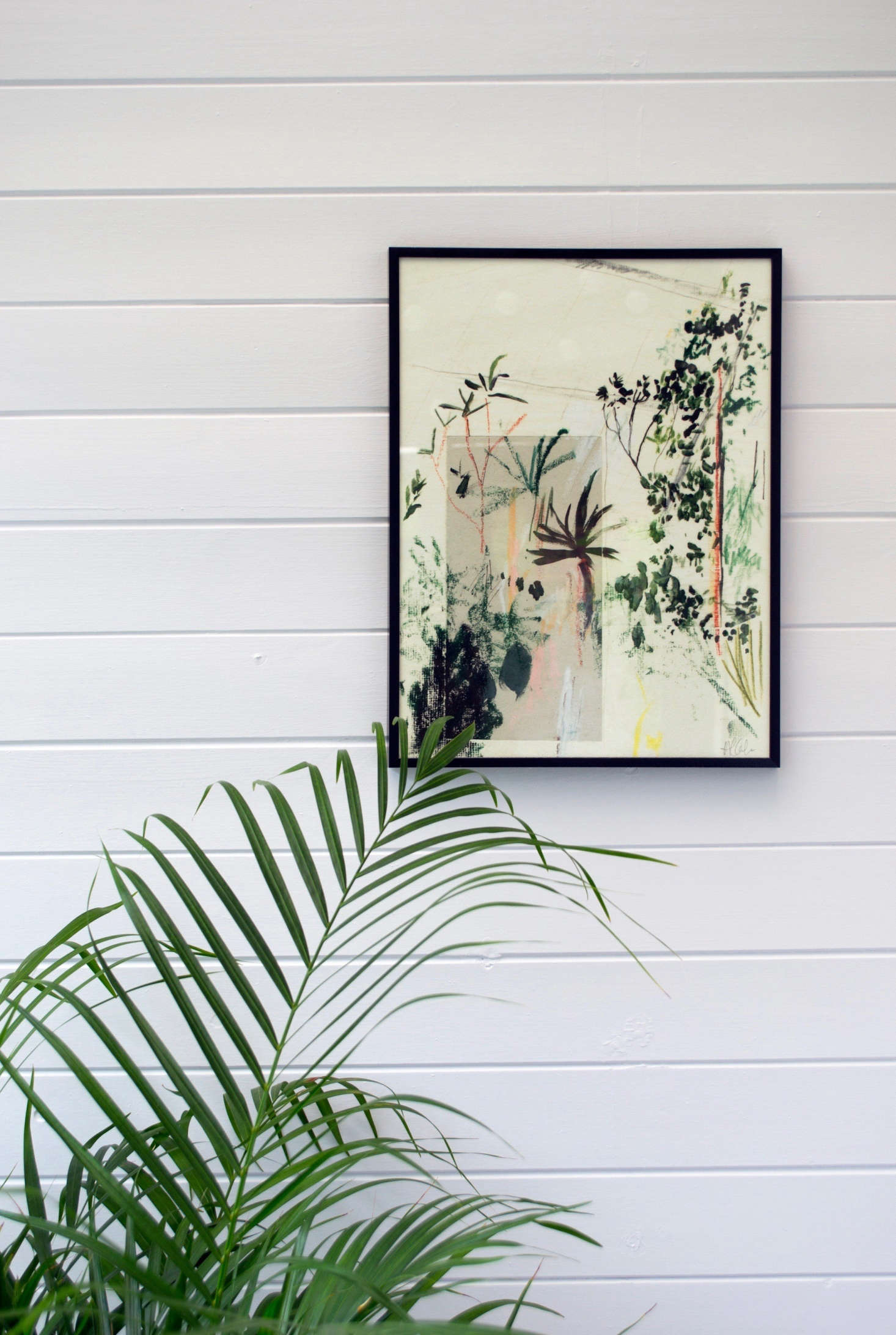 Riley placed a potted Areca palm in the back of the room to create a green backdrop.
