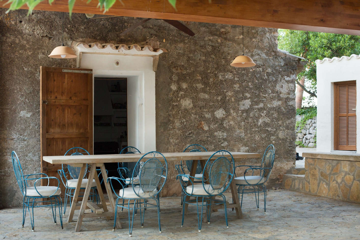 A stone courtyard has discrete areas for dining and lounging.