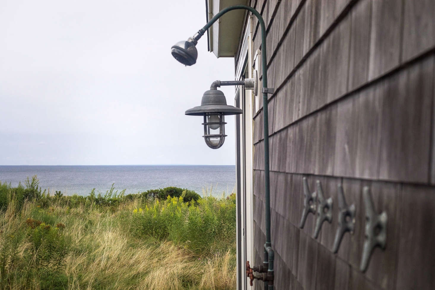 An outdoor shower-with-a-view is enhanced by simple nautical elements.