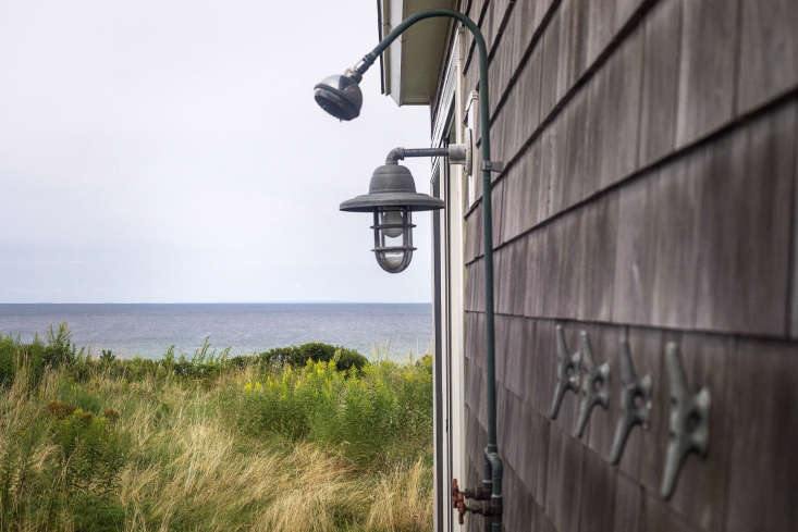 An outdoor shower-with-a-view is enhanced by simple nautical elements.