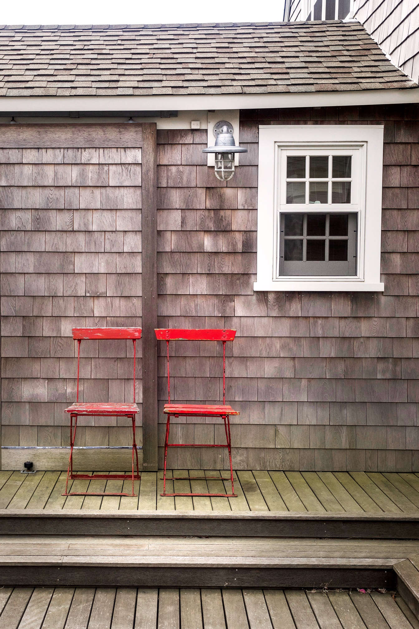A respite from the lush wilds of the front garden and grassy meadow by the bay, the courtyard deck has minimal plantings.