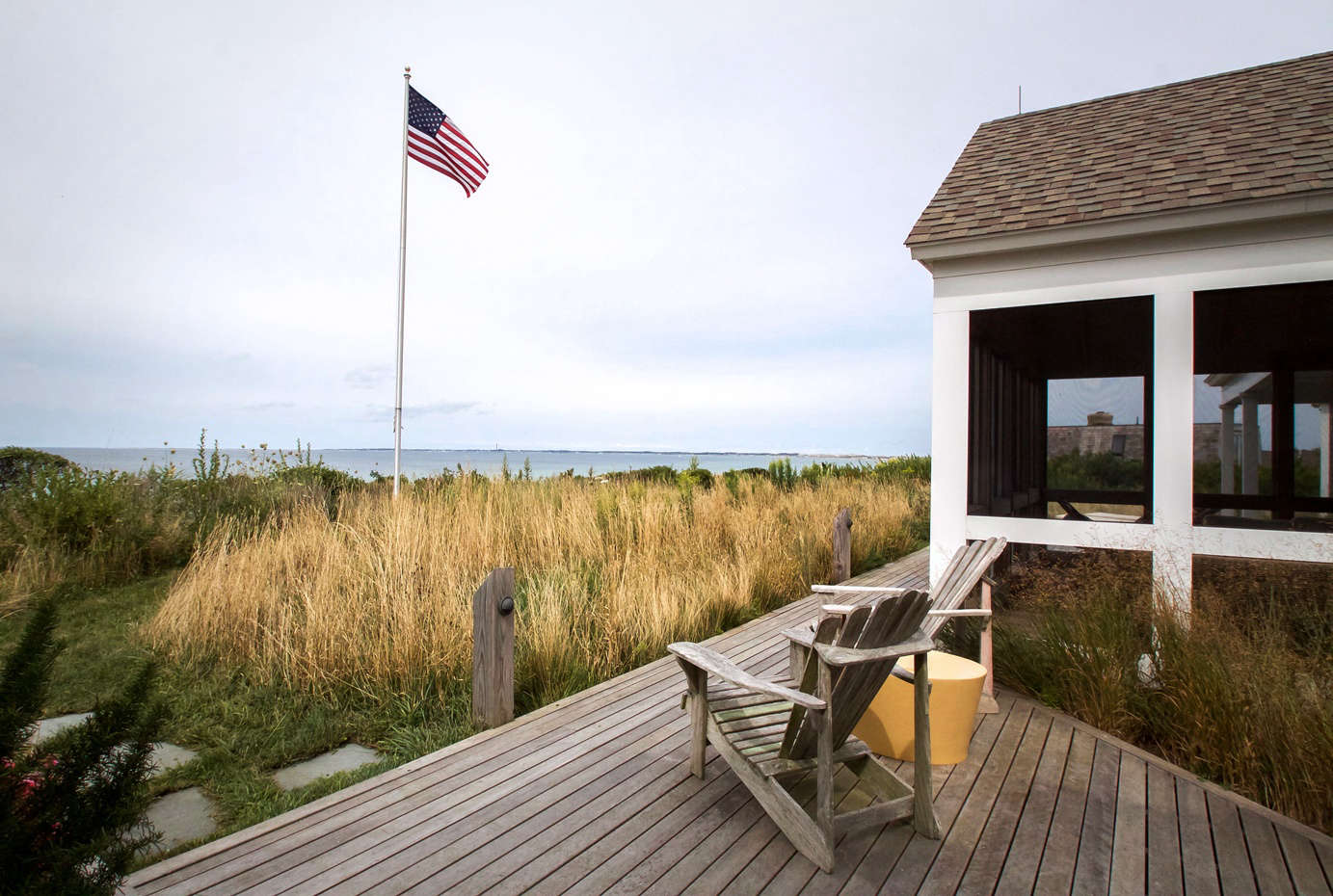 This close to the shore, the front of the complex is a protected area. No watering or fertilizer allowed here. So Tim created a soft, undulating meadow planted with a mix of conservation grass, as well as natives like Rosa virginiana and Prunus maritima or beach plum. Like the gardens towards the drive, the meadow creates a sense of softness and movement, without obscuring the view.