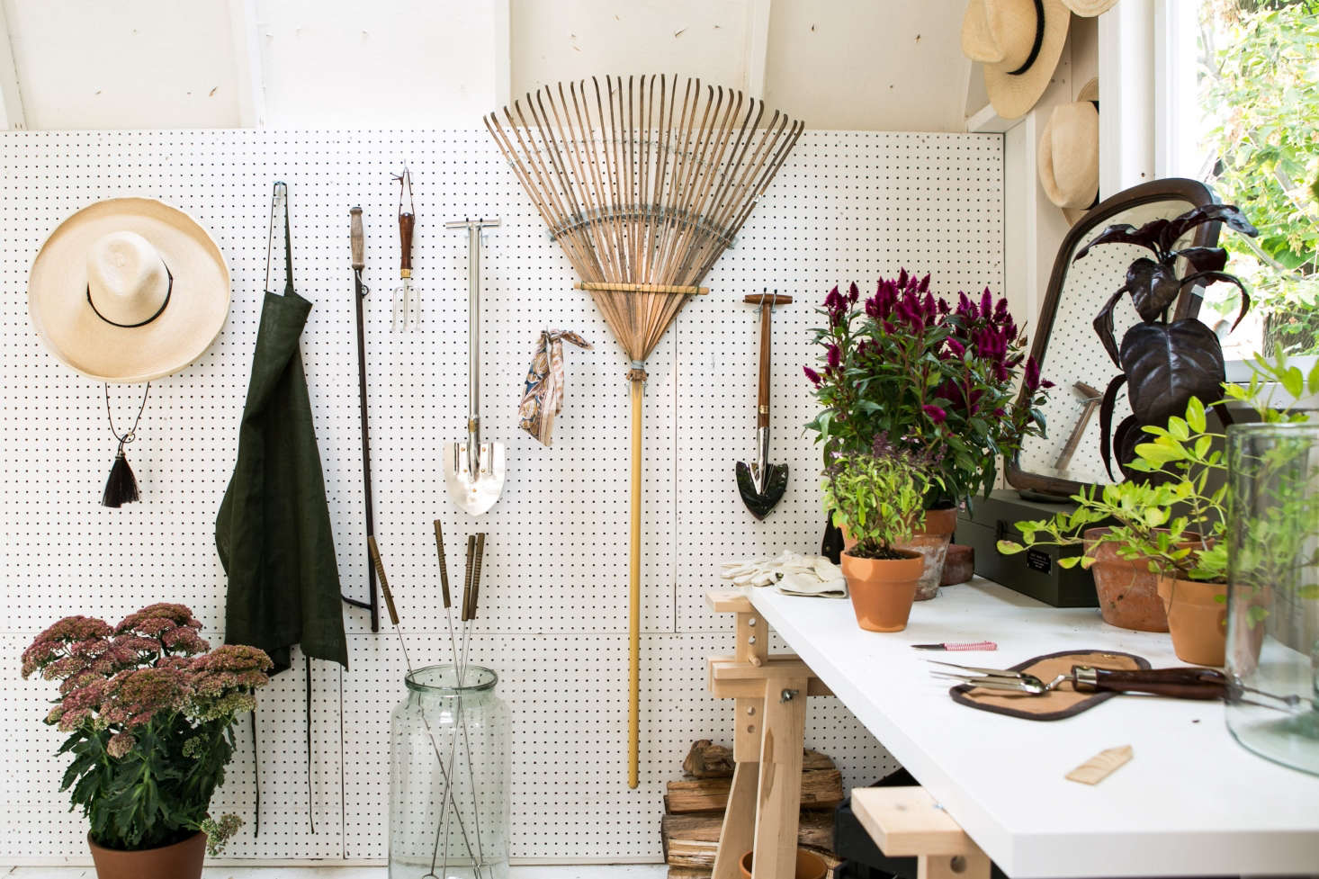 A wall of peg board keeps garden accessories and tools tidy. 