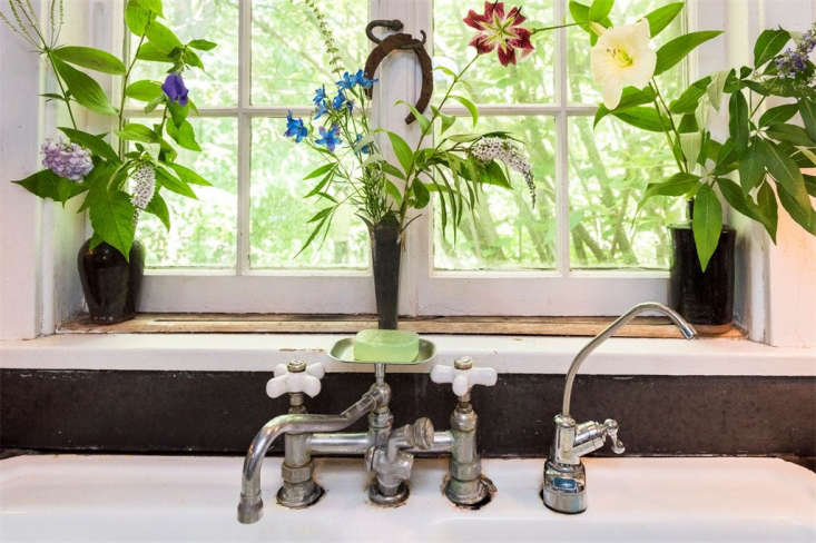 Flowers from Judy Tomkins garden are in vases on the windowsill over the kitchen sink.