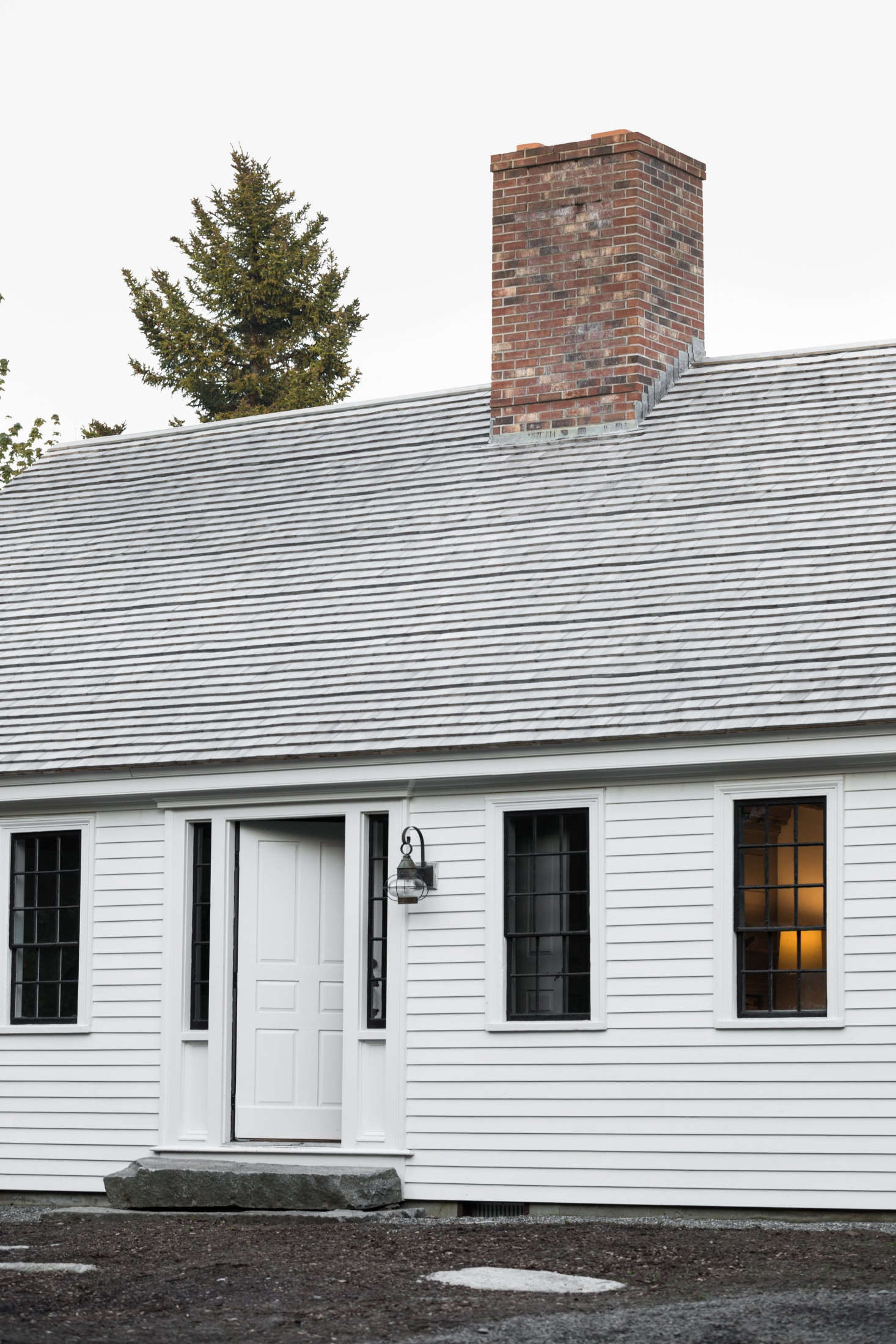 The exterior of the Cape is painted in an oyster-white milk paint. (For something similar, consider Oyster White by Old Fashioned Milk Paint.)
