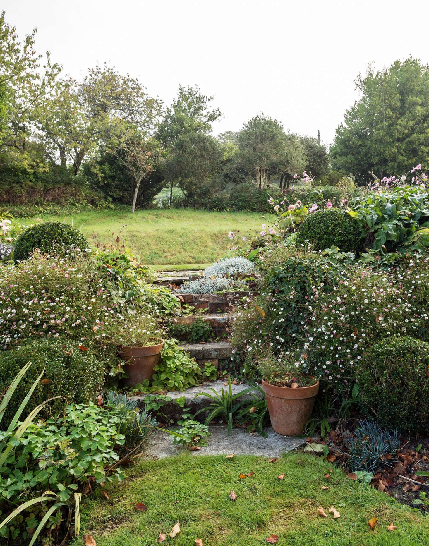 On a slope, Pentreath and McCormick connect the levels with stone stair steps.