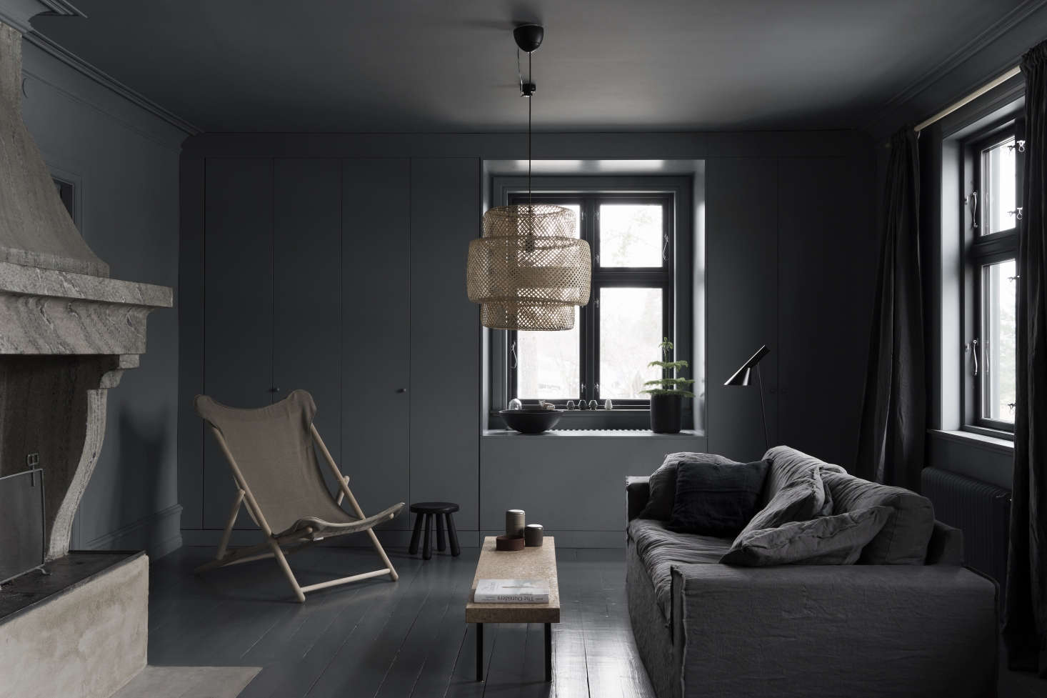 Nothing fancy in this room, yet it easily telescopes glamour thanks to its monochrome palette (with natural tones mixed in). Photograph by Stefan Isidor Bergkvist, courtesy of Skälsö Arkitekter, from Steal This Look: A Noirish Living Room in Coastal Sweden.