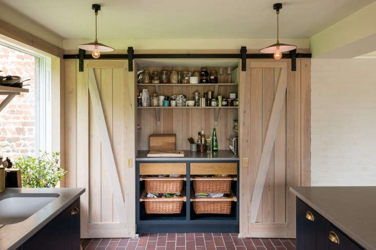 The modern root cellar; Erlam stores vegetables in baskets behind a pair of rolling barn doors.