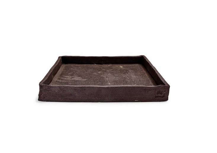 From Italy, a Flò a \1\1.8-inch-square Earth Dark Gray Ceramic Plant Tray is handmade; &#8\2\20;its roughly hewn form and slightly mottled surface fits perfectly in the natural surroundings of a garden,&#8\2\2\1; notes retailer ABC Home. It is on sale for \$39.