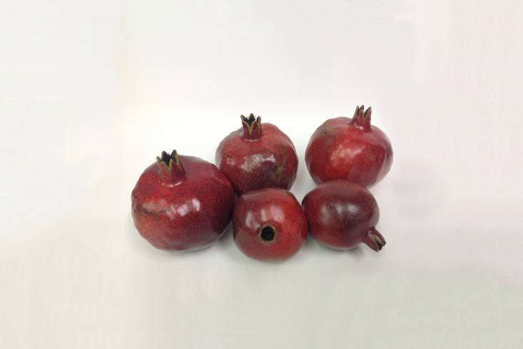 Penkridge Ceramics in Birmingham, England has been making porcelain fruit and vegetables since \1984. You can source the range of produce from John Derian in New York City and Sweet Bella online as well as directly from Penkridge Ceramics in the UK. Shown here are the red pomegranates.