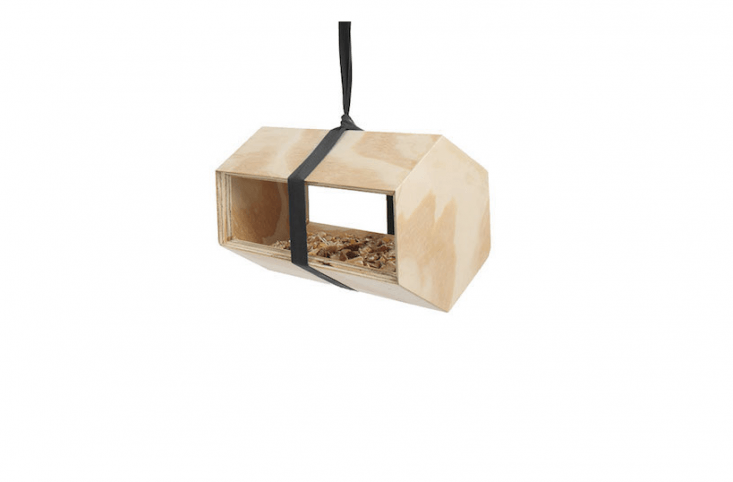 A Neighbirds feeder and birdhouse designed by Andreu Carulla and made of untreated pine has a polyester hanging strap; \$38 from Luminaire.