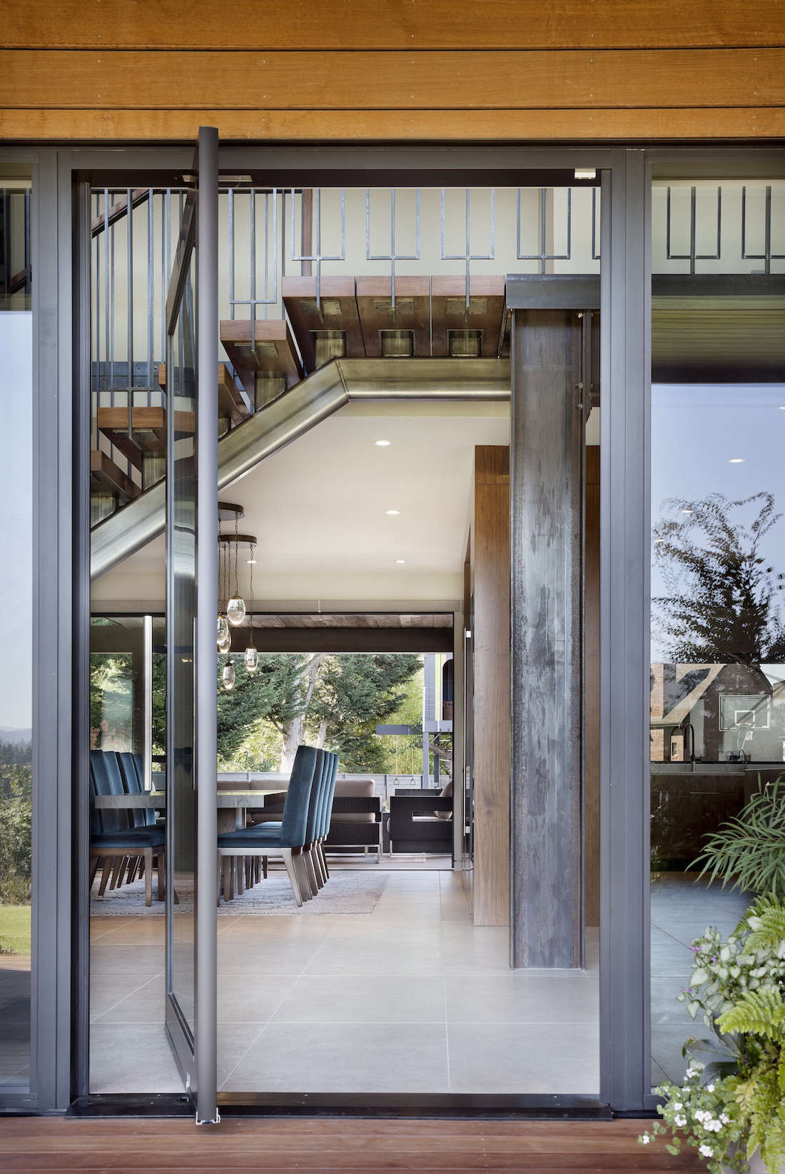 Pivot doors off the house encourage an indoor-outdoor flow.