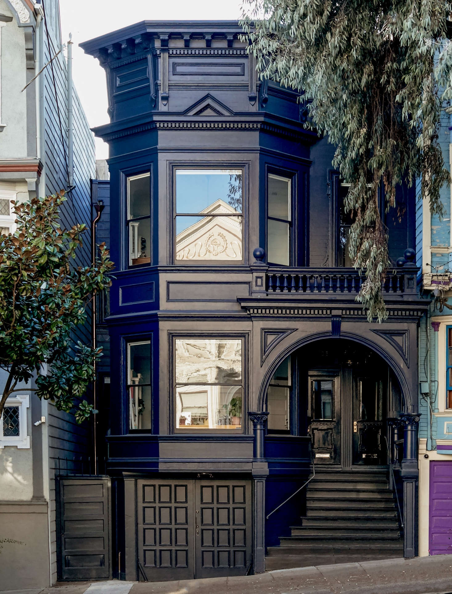 A dark blue facade, accented by glossy black trim and a copper downspout, lends an elegant air to a facade in Before & After: Moody Blues for an Elegant Victorian in San Francisco. Photograph by Daniel Dent.