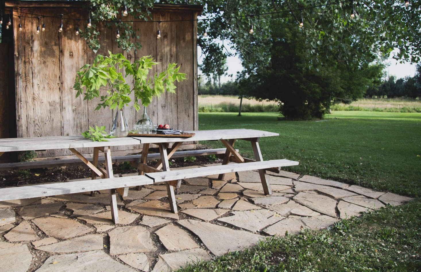 The terrace is positioned next to an existing weathered shed (which provides crucial storage for cabin life). Not including the lights, the tally came in at about $500: $370 for the flagstones, $75 for the skid steer (explanation below), $ for the substrate, and $30 for compost.