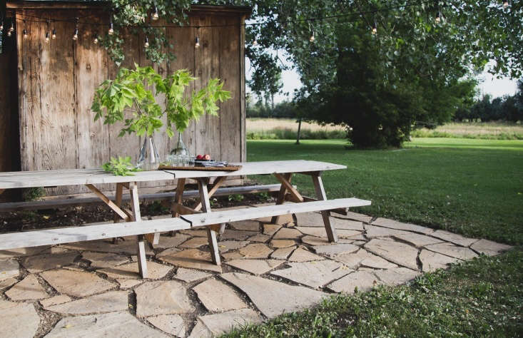 The terrace is positioned next to an existing weathered shed (which provides crucial storage for cabin life). Not including the lights, the tally came in at about \$500: \$370 for the flagstones, \$75 for the skid steer (explanation below), \$\25 for the substrate, and \$30 for compost.